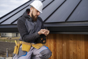 man fixing gutter drainage problems